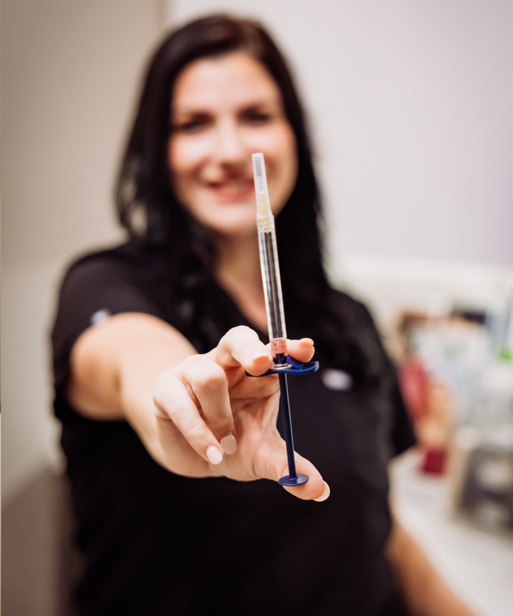 Dana preparing injectables in the treatment room at The Bluffs